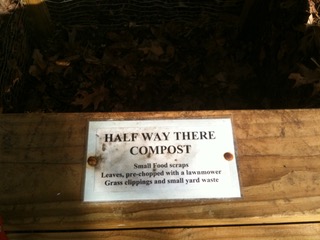 Sign on a compost bin that reads, "Halfway there compost"