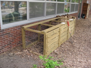 A wooden compost bin built by Get Dwell