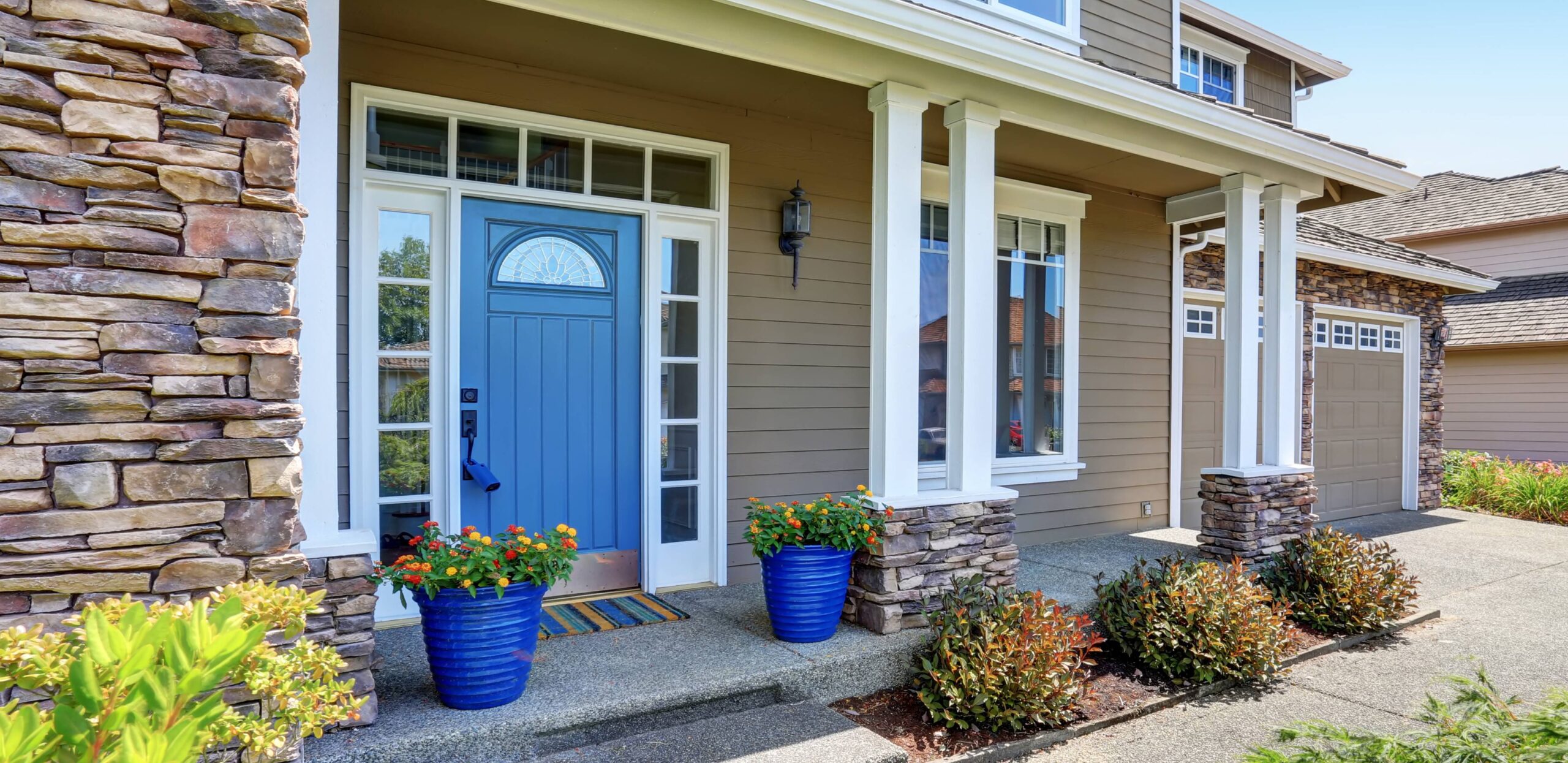 A welcoming entrance to a high end home with a bright blue door