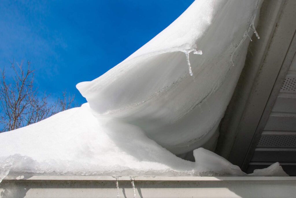 A close up of a roof with too much snow on it