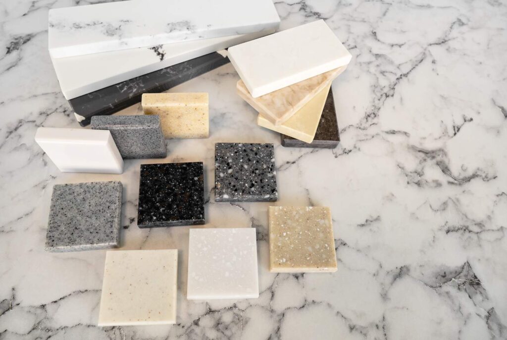 engineered quartz countertop replacement samples on a marble countertop