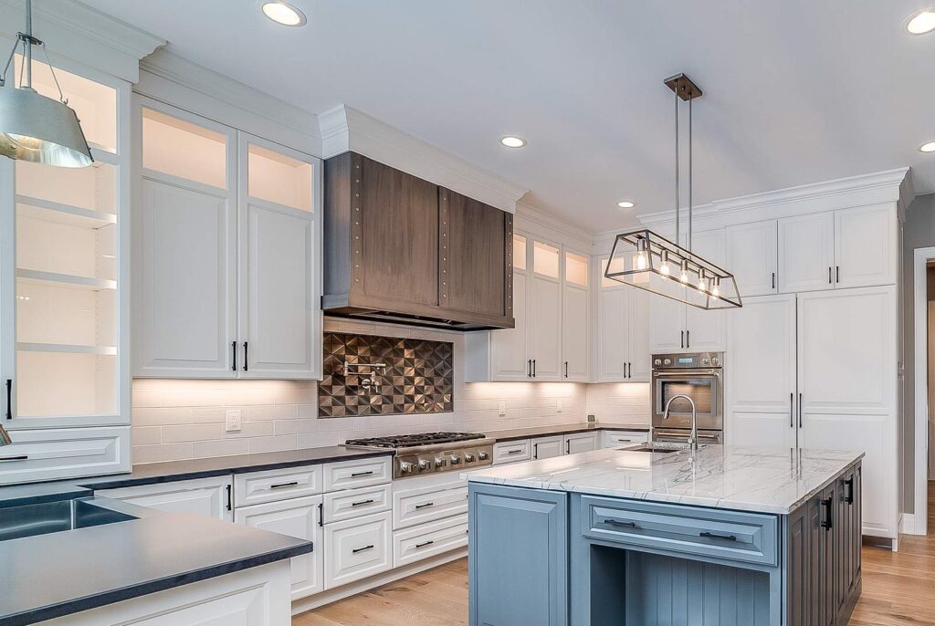 A neo-traditional kitchen with a statement range hood