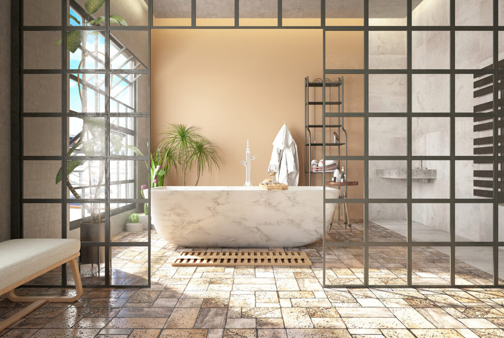 a luxurious, modern bathroom with a marble bathtub, stone flooring and large windows