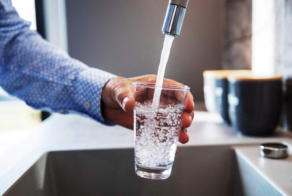 man getting a glass of water