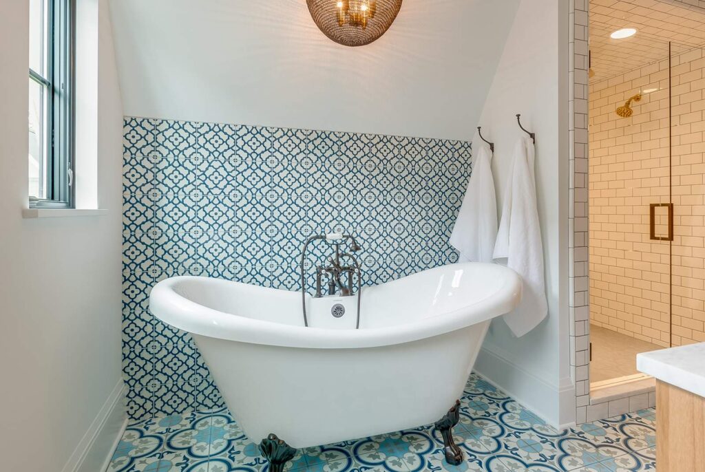 free standing tub with a custom tiled backsplash