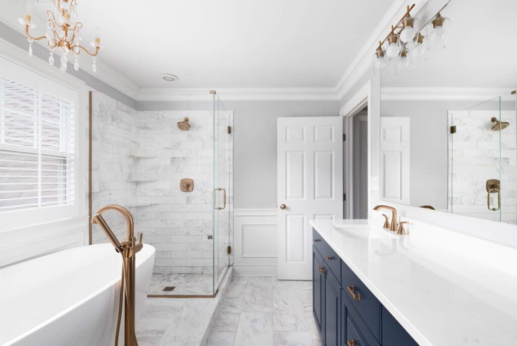 Upscale Bathroom remodel with a neo-angle shower with ceramic tile walls, body-spray fixtures, frameless glass enclosure, freestanding soaker tub with high-end faucets, stone countertops, tile ceramic floor and in-floor heating