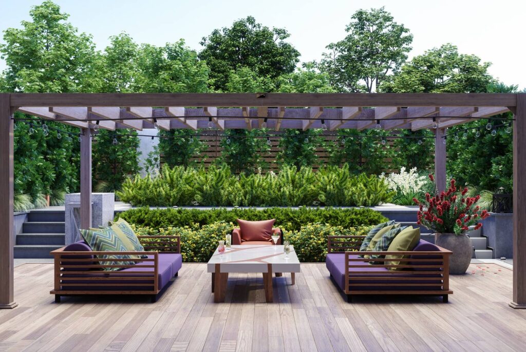 A high end wooden deck with a wooden pergola and plush couches