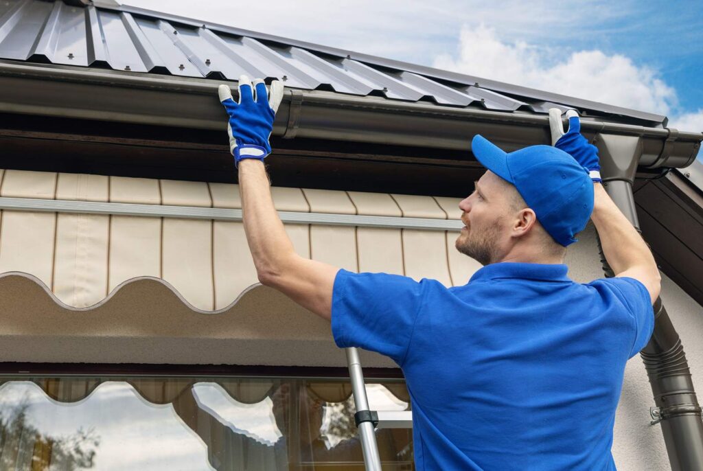 Get Dwell team member on a gutter and downspout repair service call.