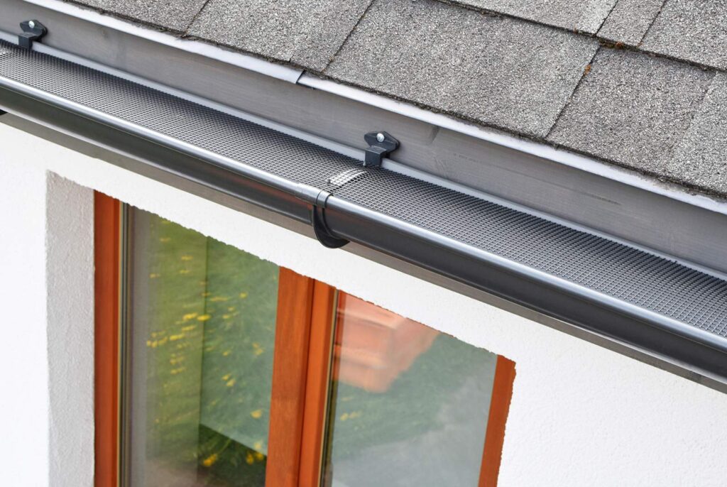 Close up of a Get Dwell Gutter Guard Installation on a white stucco Chicago area home