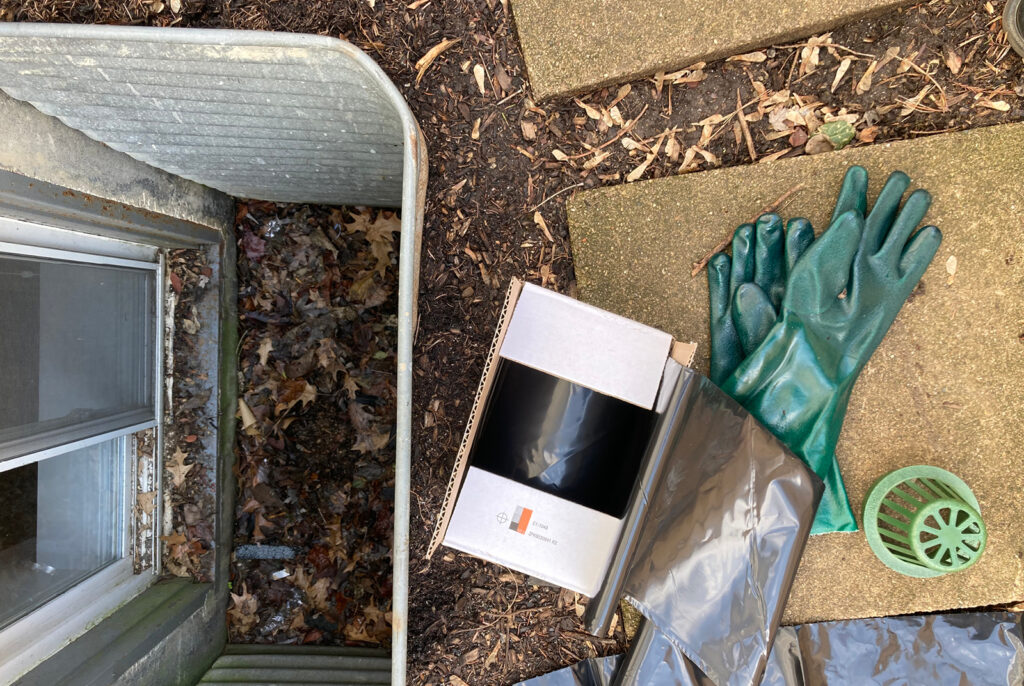 A Get Dwell crew cleans out window wells and installs a raised atrium grate 