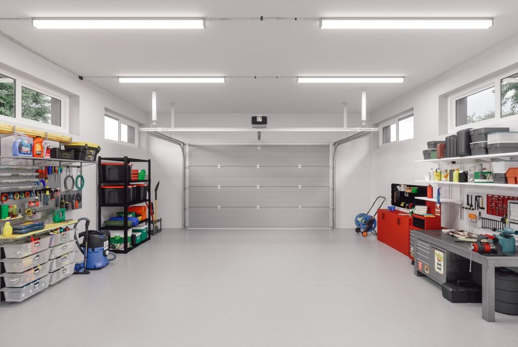 Clean garage with pegboard tool walls, wire shelving, labeled bins, a red tool cabinet and a workbench.